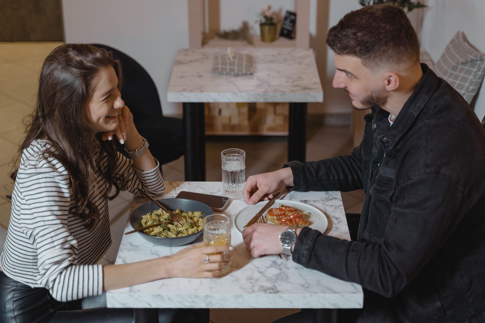 A couple sharing a meal at a restaurant table